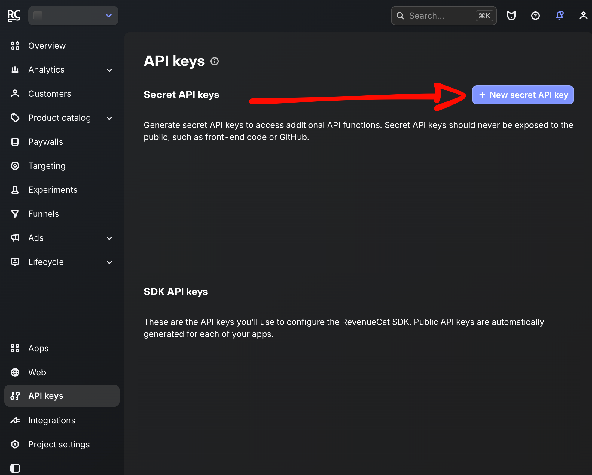RevenueCat API keys page with an arrow pointing to the New secret API key button
